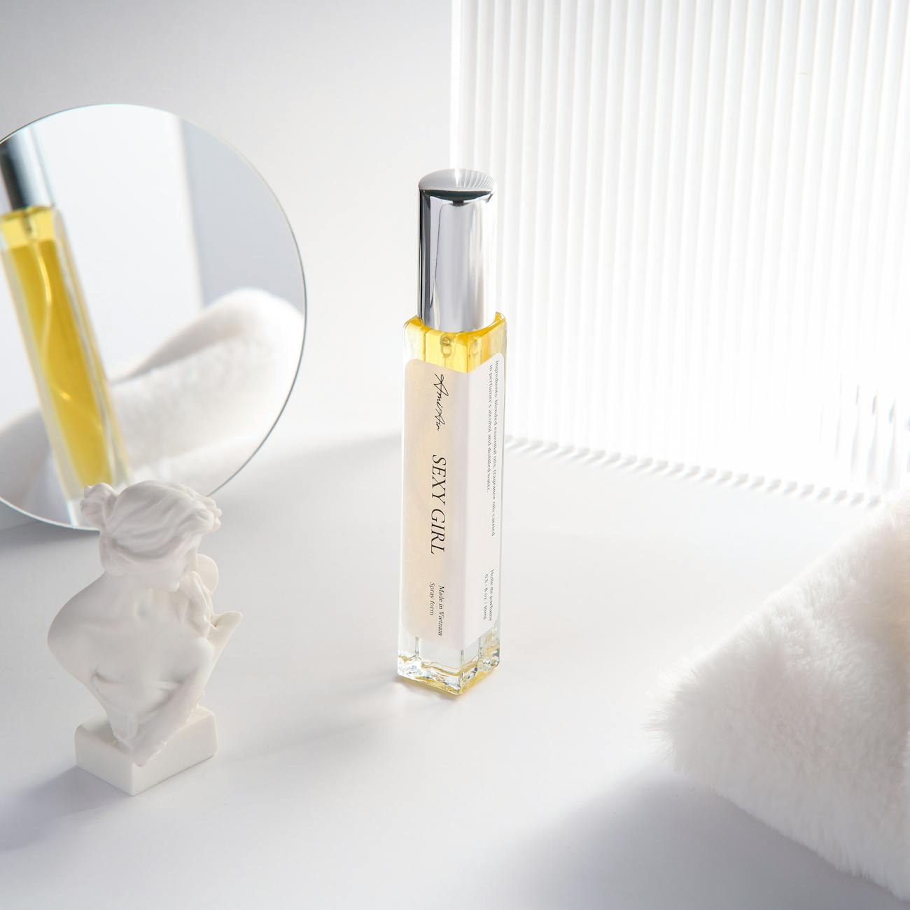 Studio workspace with fragrance bottles, diffusers, and styling props arranged for product photography